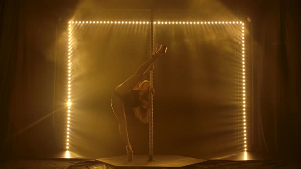 Girl with Sexy Shape Is Dancing Near the Pole, Yellow Smoke and Neon Lighting Background alt