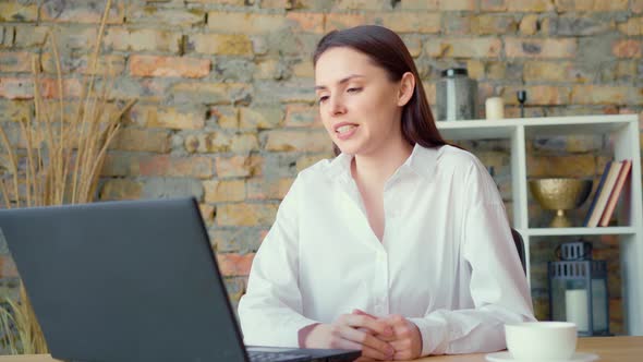 Confident Smiling Businesswoman Having a Video Conversation in Office alt