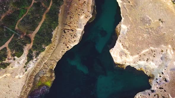 An early morning Birds Eye View to Close Up of the picturess St Peters Pool Malta displaying the san alt
