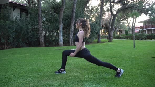 The girl goes in for sports, yoga, stretches, does gymnastics, morning exercises. A girl is watching alt