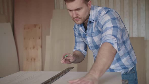 Carpenter Makes Pencil Markings on the Blank with the Help of a Ruler