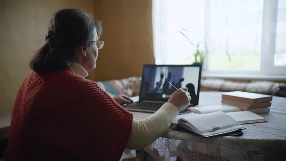 Distance Learning, an Elderly Modern Woman a Pensioner Masters a Modern Profession with Help of alt