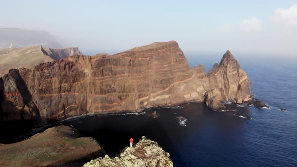 Man Standing on Mountain Top at Ponta de Sao Lourenco, Madeira Island, Portugal.