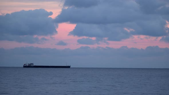 Cargo Ship On the Horizon  Evening Sky With Clouds