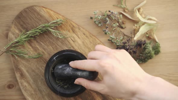 The Women Pounding Spices and Herbs in Mortar for Food Cooking Hold Pestle with Mortar alt