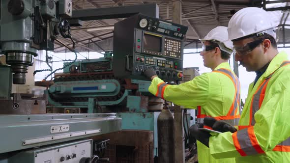 Group of Factory Workers Using Machine Equipment in Factory Workshop alt