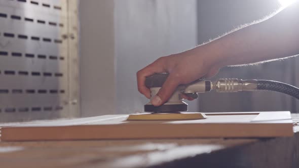 Slow motion of a worker polishing a cabinet door in a furniture factory alt