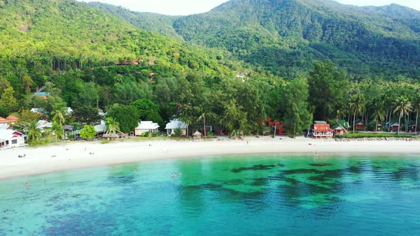luxury resorts on the sandy Thailand coast. emerald seawater and jungle in the background alt