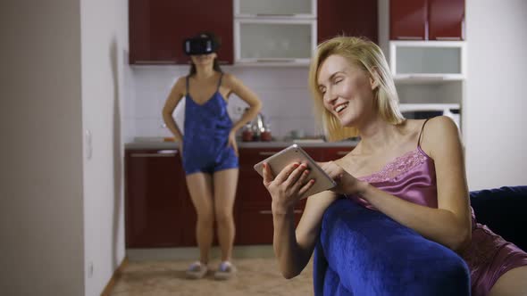 Young Woman Using Virtual Reality Glasses at Home alt