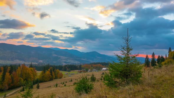 Autumn. Cloudy Sunrise over Mountain Village with Forest alt