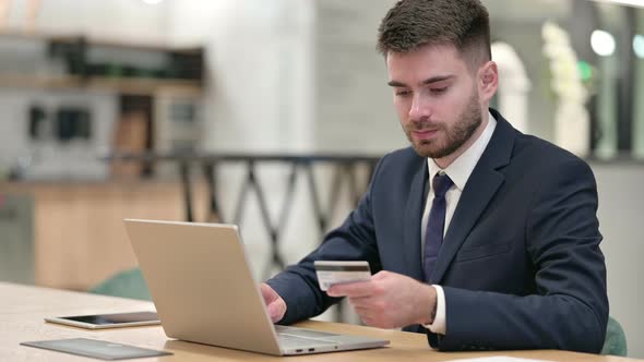 Online Payment Success on Laptop for Young Businessman in Office  alt