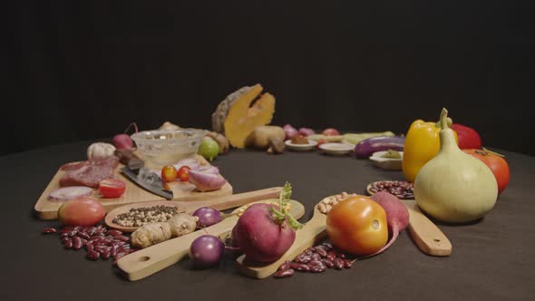 Fresh Meats, Vegetables Nuts And Spices Are Laid Out On A Black Table alt