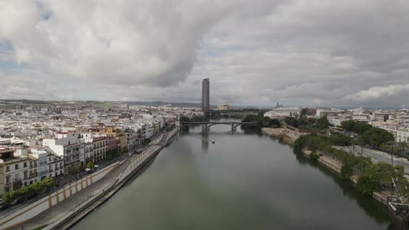 Aerial view over Guadalquivir river, Seville; Sevilla Tower on bank