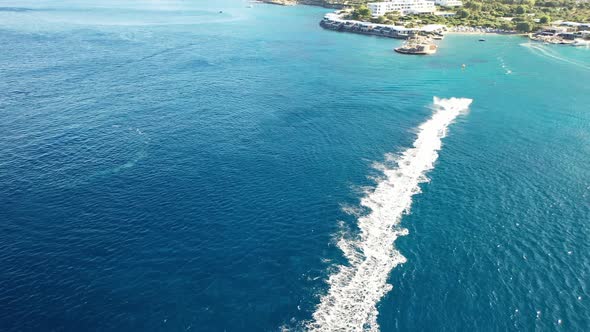 Aerial View of a Jet Ski Boat in a Deep Blue Colored Sea. Spinalonga Island, Crete, Greece