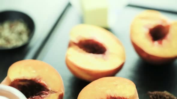 Cutting peaches in half for making grilled peaches. alt