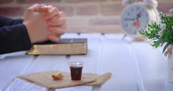 Young Woman Praying and Taking Communion