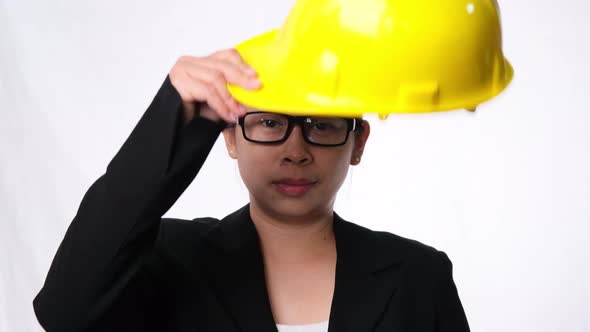Woman technician smiling with helmet. Confident woman construction worker on white background. alt