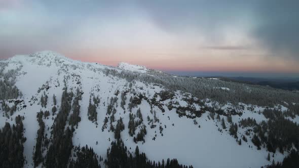 Aerial view of snowy mountain slope in Oregon, drone video of winter landscape alt