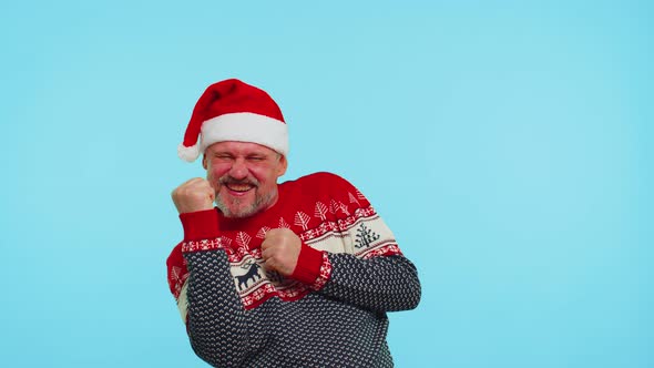 Cheerful Man in Sweater Christmas Santa Shouting Celebrating Success Winning Goal Achievemen alt