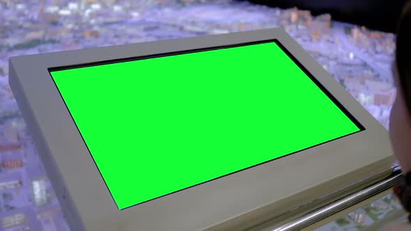 Woman Looking at Blank Green Display Kiosk at Exhibition - Green Screen Concept