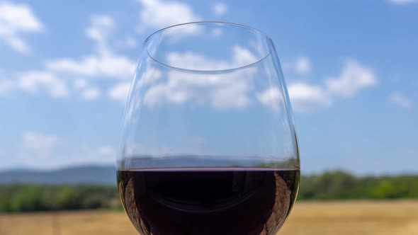Glass of Red Wine Against Blue Sky alt