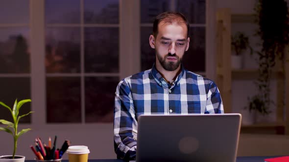 Caucasian Freelancer Thinking While Working in His Home Office alt