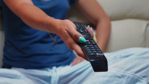 Switching Tv Programs Sitting on Sofa alt