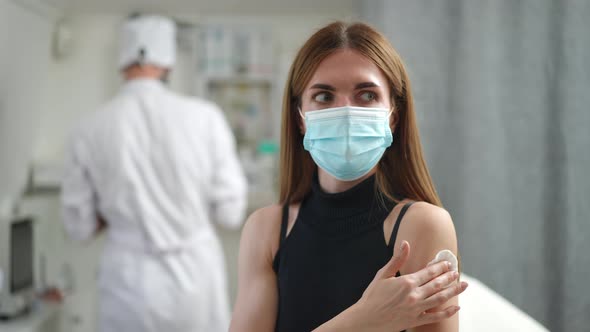 Positive Young Woman Gesturing Thumb Up After Vaccination in Clinic Indoors alt