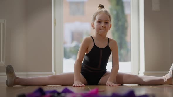 Wide Shot Teenage Girl Sitting on Twine Bending Forward in Slow Motion alt
