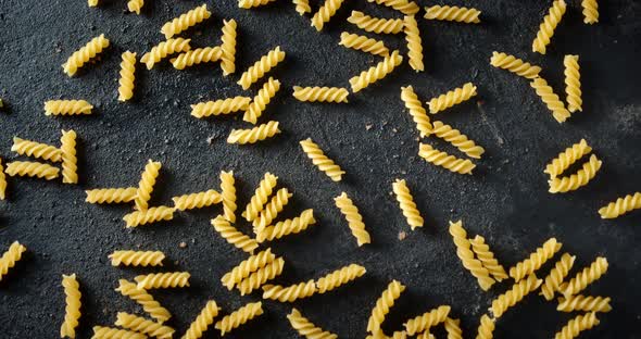 The Dry Fusilli Pasta on Table Slowly Rotates alt