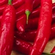 On Wood Plank Ripe Red Long Hot Chili Peppers are the World&#39;s Number One Culinary Delight and Cash - VideoHive Item for Sale