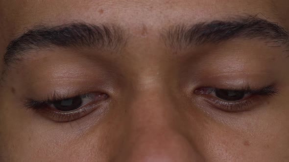 Extreme Close Up Afro American Man with Brown Eyes Expressing Sadness Slow Motion alt