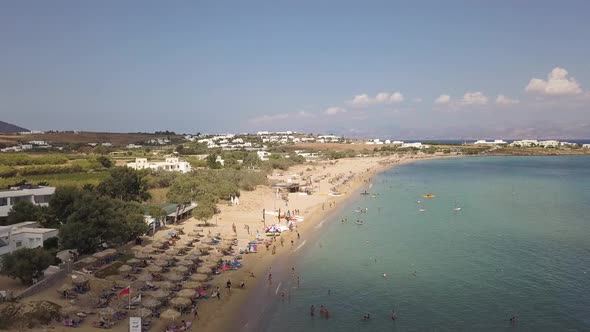 Flyover of tourists enjoying Golden Beach on the greek island of Paros; Aegean Sea; summer vacation; alt