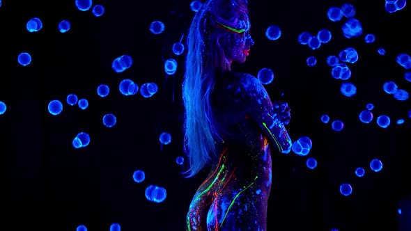 Woman with Colorful Glow Body Art Stand in Uv Bubbles