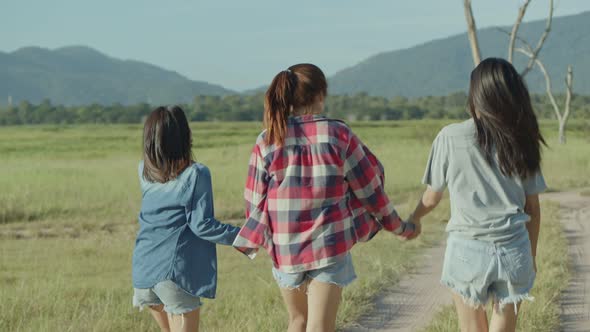 Group of a young Asian woman with friends happy camping in nature having fun.