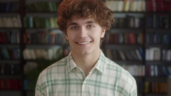 Happy Positive Man Laughing at Funny Joke Looking at Camera in Library