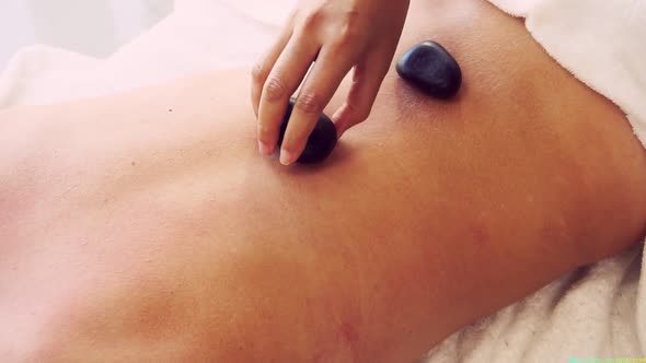 Hot Stone Massage Treatment By Therapist in Spa alt