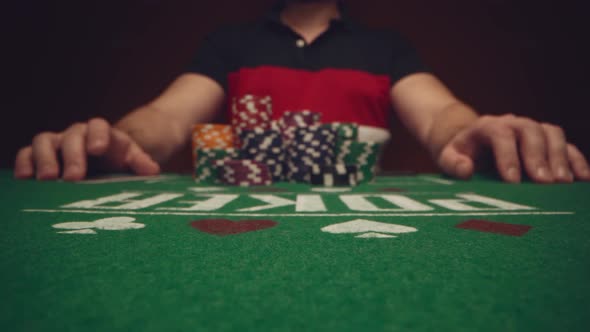 Male Player Betting All Chips in While Playing in Casino Close Up