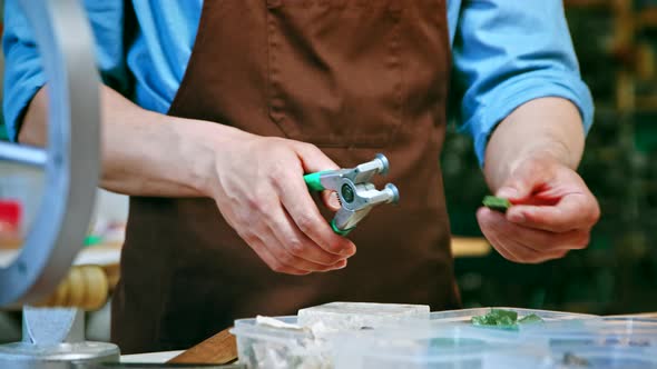 Male hands cutting a piece of stone alt