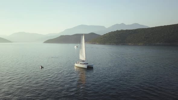 Aerial view of Yacht cruising on the sea or ocean in summer day in Montenegro alt
