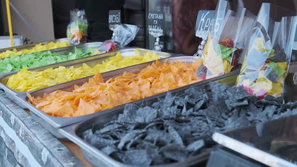 Colorful Potato Chips on Street Food Showcase. Street Fast Food at the Festival alt