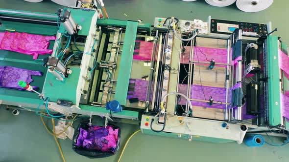 Top View of a Colourful Plastic Bag Manufacturing Machine at a Polyethylene Production Factory alt
