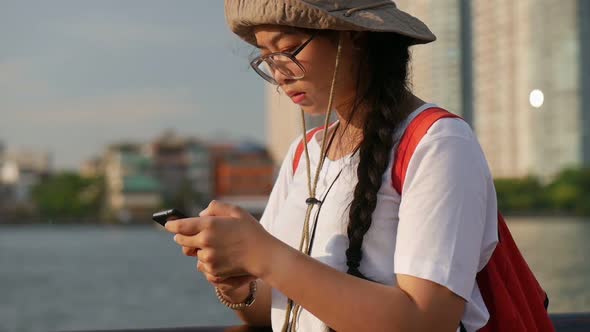 Young Asian women using mobile chatting online.