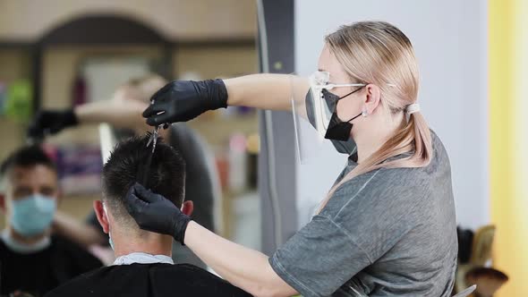 A hairdresser with security measures for Covid-19, c