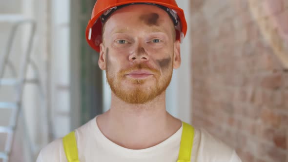 Close Up of Smiling Construction Worker in Safety Uniform Posing at Camera alt