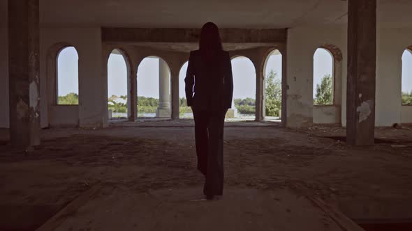 Back View Brunette Walks in Forsaken Building alt