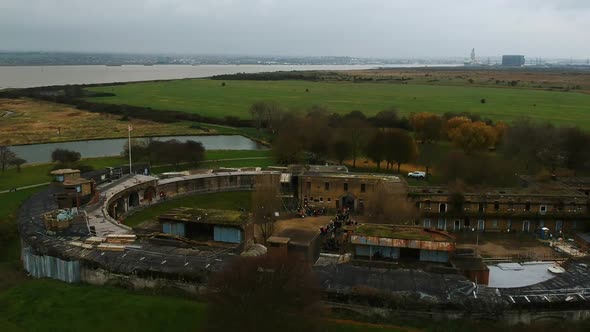 Flying away from the historic Coalhouse Fort in Essex, England. East Tilbury. River Thames in backgr alt
