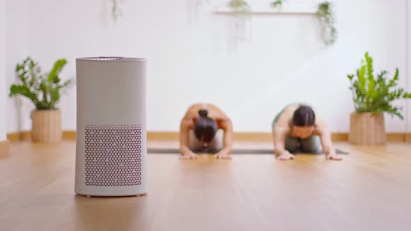 Air purifier in cozy white Living room for filter and cleaning removing dust PM2.5 HEPA at home with alt