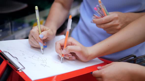 Closeup of Women's Hands Checking Ballpoint Pens in a Stationery ...