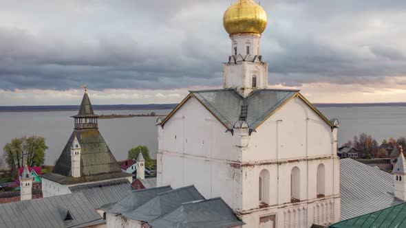 View of the Church of the Savior in the Seny in Rostov Kremlin in front of a colorful sunset.